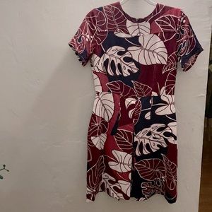It’s a burgundy dress with leaves design
